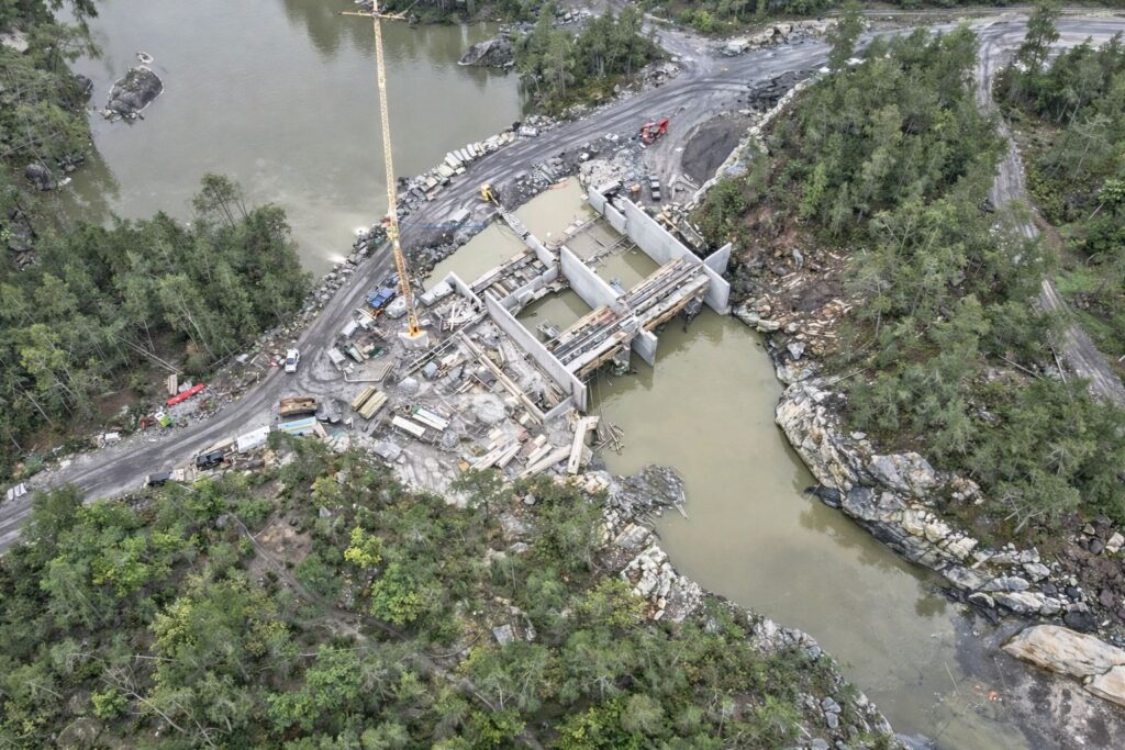 The intake structure and weir structure are integrated directly into the rocky landscape of the Nidelva.